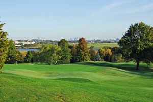 The 13th green with a view of the Boston skyline in the background